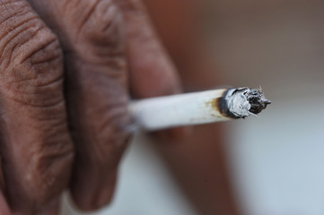 Close-up of hand holding cigarette
