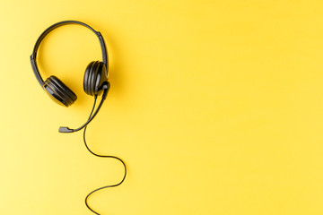 Overheadshot of headset on background with copyspace. Call center concept