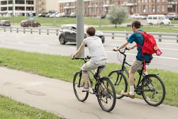 Healthy lifestyle - people riding bicycles in city.