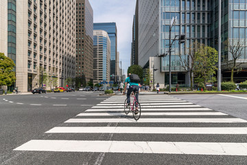 Cycling through the Uchibori Dori street, Chiyoda district, in downtown Tokyo, Japan