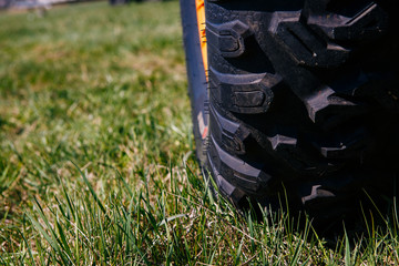 Wheel of quad bike atv on the grass