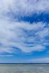 Beautiful seascape. Vertical color photography of blue sky and Egyptian island seen far away in distance at horizon. 