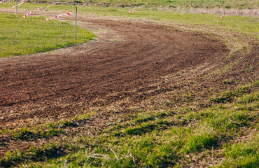 Turn of atv race track. Dust and grass