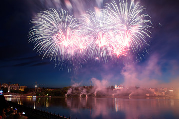 Beautiful pyrotechnic fireworks at night over the water. Celebration.