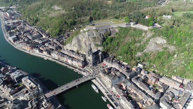 Aerial bird view of Dinant a Walloon city and municipality located on the River Meuse in the Belgian province of Namur showing the famous citadel and the gothic notre dame cathedral 4k high resolution