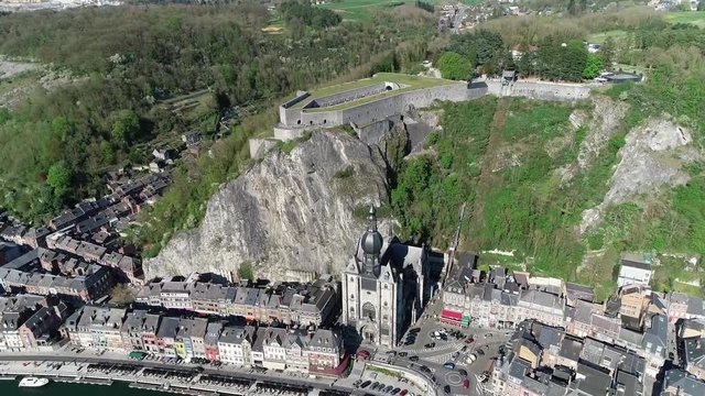 Aerial view of Dinant a Walloon city and municipality located on the River Meuse in the Belgian province of Namur showing the famous citadel and the gothic notre dame cathedral 4k high resolution