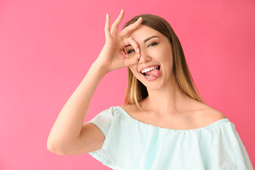 Funny young woman on color background