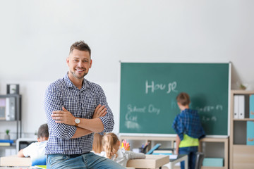 Portrait of male teacher in classroom