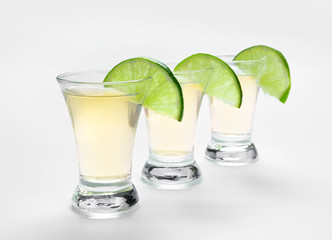 Shots of tequila on white background