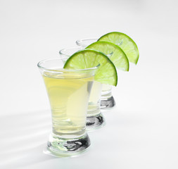 Shots of tequila on white background