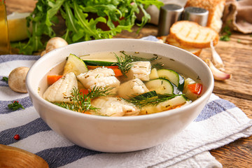 Bowl of tasty soup on table