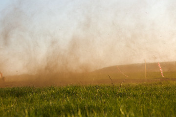 Cloud of dust on atv race track.