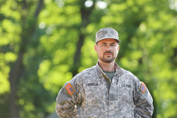 Male soldier in camouflage outdoors