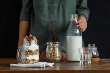 The glass of granola with dried berries and yogurt.