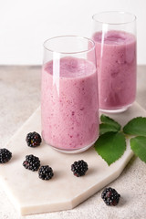 Glasses with tasty blackberry cocktail on table