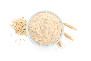 Bowl with tasty oatmeal on white background
