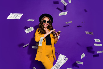 Portrait of her she nice lovely cheerful cheery rich wealthy confident wavy-haired lady throwing away 100 million budget expenses isolated over bright vivid shine violet lilac background