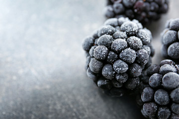 Tasty frozen blackberries on dark table, closeup