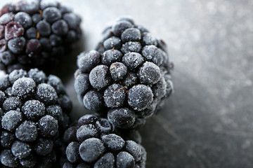 Tasty frozen blackberries on dark table, closeup