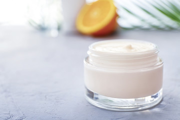 Jar of body cream on white table