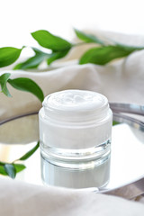 Fototapeta na wymiar Jar of body cream with herbal extract on table