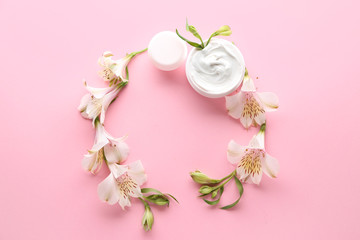 Frame made of natural cream with flowers on color background