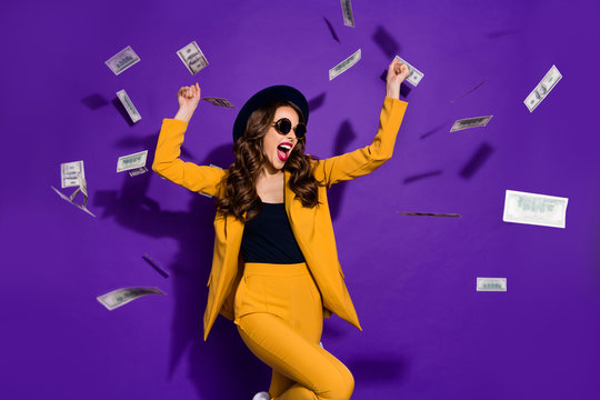 Portrait of her she nice lovely trendy cheerful rich wealthy wavy-haired lady winner currency flying 100 million budget winning isolated over bright vivid shine violet lilac background