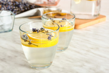 Glasses of tasty infused water on light table