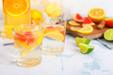 Glasses of tasty infused water on light table