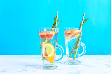 Glass cups of tasty infused water on light table
