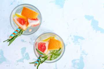Glasses of tasty infused water on light background