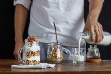 The glass of granola with dried berries and yogurt.