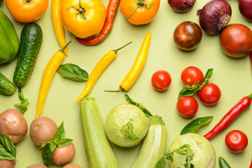 Assortment of fresh vegetables on color background