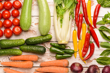 Assortment of fresh vegetables on white wooden background
