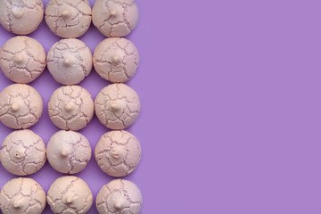top view on meringues arranged on colored background with copy space on the right