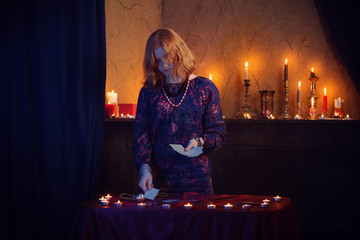 Young woman with divination cards in room