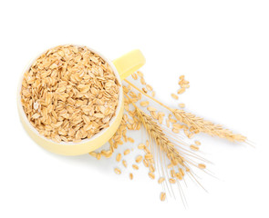 Cup with raw oatmeal on white background