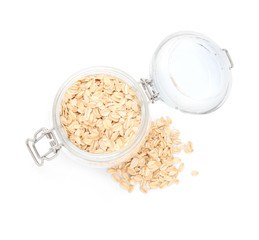 Jar with raw oatmeal on white background