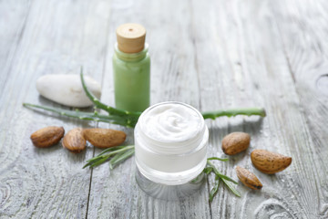 Jar of natural cream on wooden background