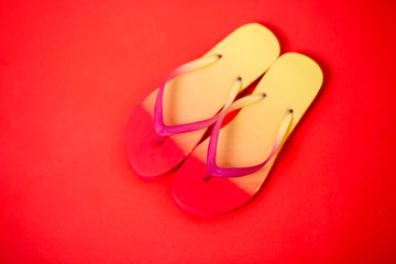 Beach flip flop on red background