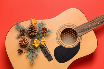 Guitar and Christmas decor on color background