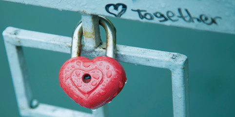Close up heart shaped love padlock with description TOGETHER - beautiful wedding day custom.