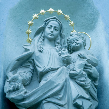 Ancient statue of the Virgin Mary with Jesus Christ. Religion, faith, love, Christianity concept.