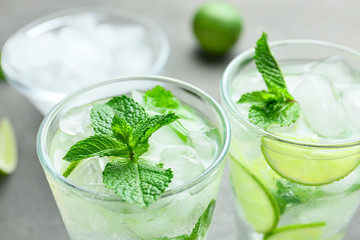 Glasses of fresh mojito on table, closeup