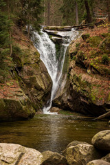 Fototapeta na wymiar Waterfall in a Autumn deep forest. Natural background. Karpacz, Poland, Europe