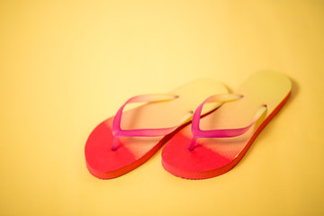 Beach flip flop on yellow background