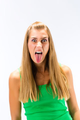 Young woman showing her tongue