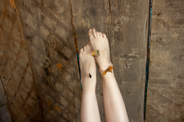 beautiful legs raised up. Butterflies are sitting on their feet. Lightness of legs.