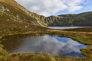 Looking past a small Pond and on towards Green Hill and Loch Brandy, situated in Glen Clova in the Angus Glens of Scotland.