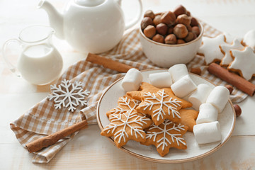 Composition with tasty Christmas cookies, marshmallow and milk on table